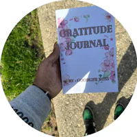 a person holding a gratitude journal